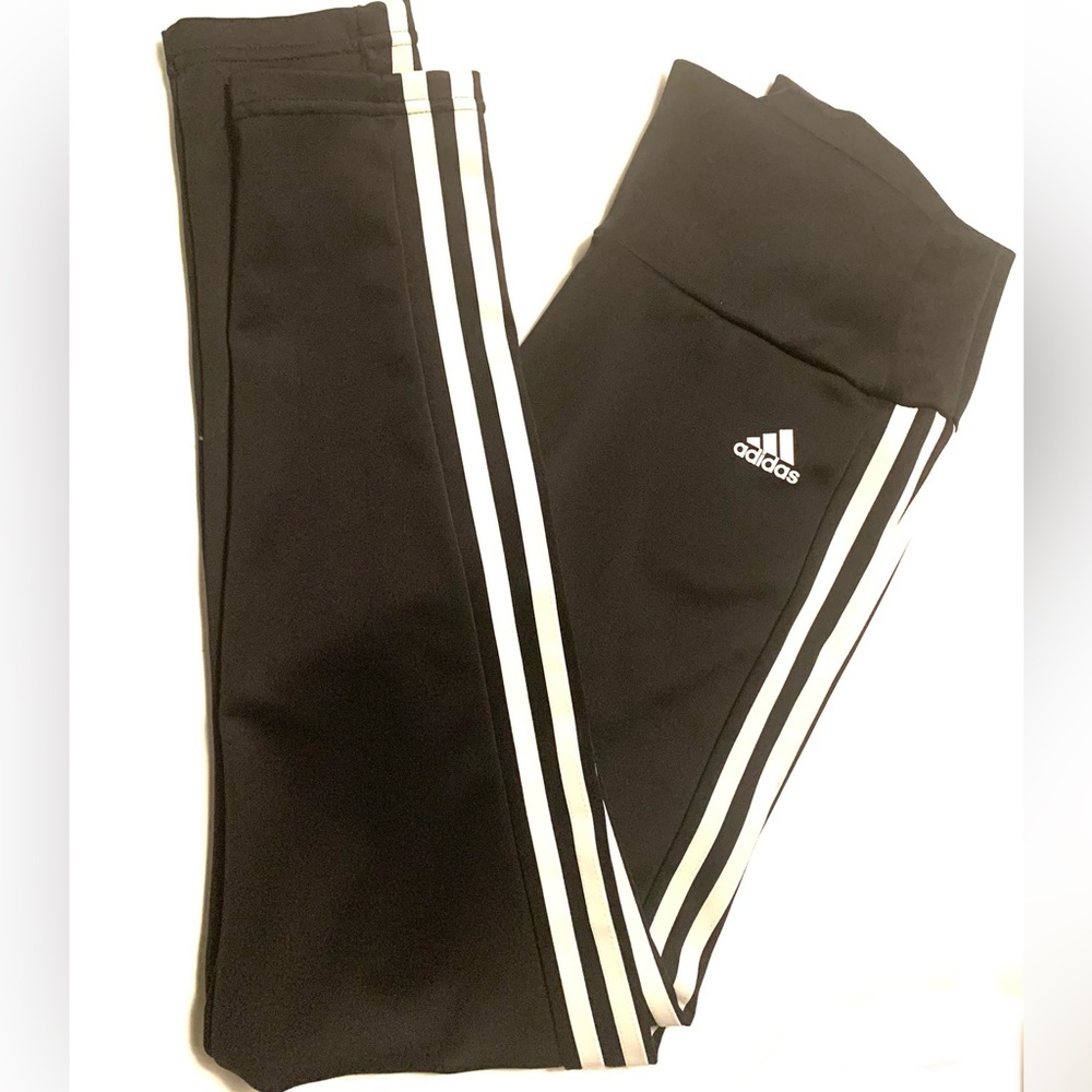 Adidas AEROREADY black tights with white signature stripes on the side.